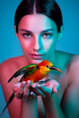 Woman holding colorful toucan bird
