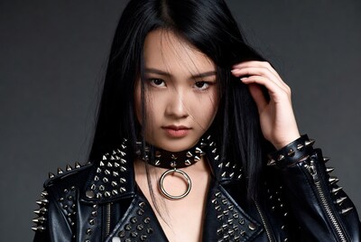 Asian woman in spiked leather jacket