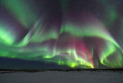 Vibrant Northern Lights over Snowy Landscape
