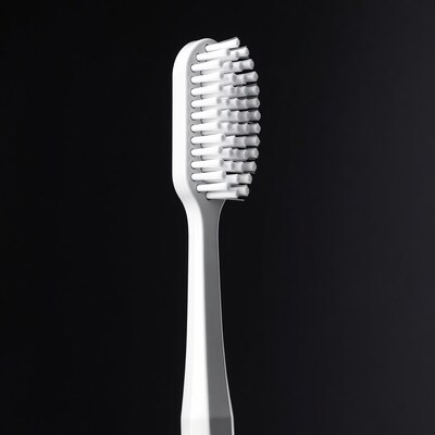 White toothbrush on black background