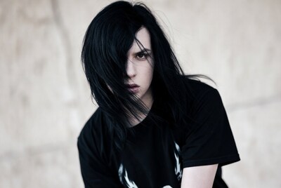 Man with long black hair in black shirt