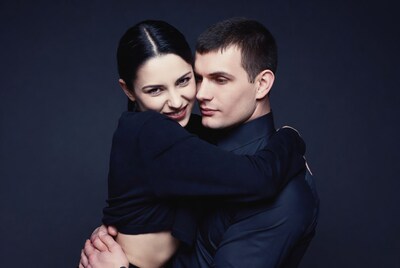Man embracing woman closely