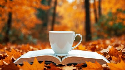 White Mug on Open Book with Autumn Leaves