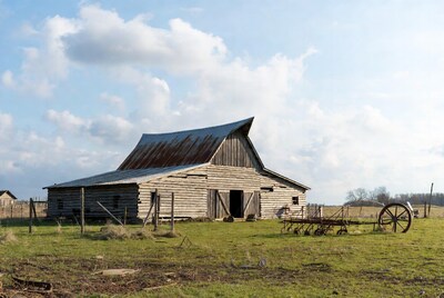Old wooden barn in grassy field