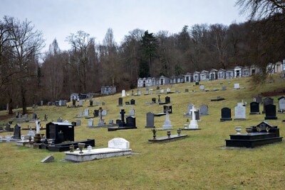 Graveyard with tombstones on grassy hill