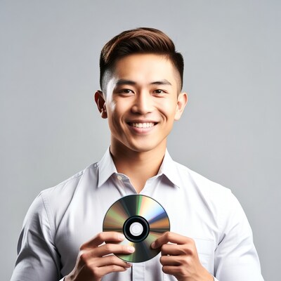 Asian man holding CD disc