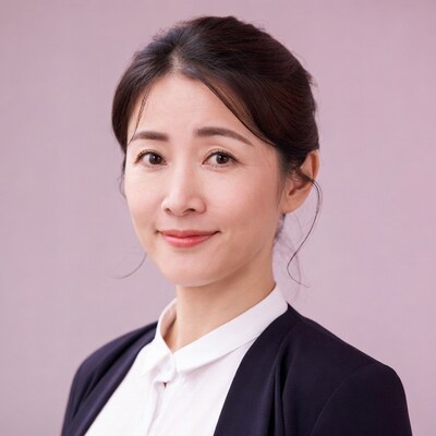 Asian woman in navy blazer smiling