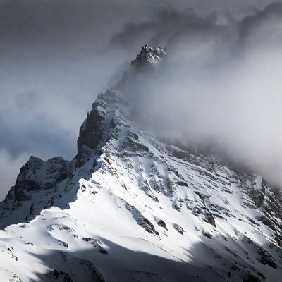 Snowy Mountain Peak in Clouds