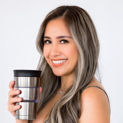 Smiling Asian woman holding tumbler