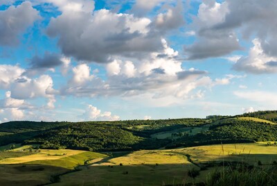 Rolling green hills under cloudy sky