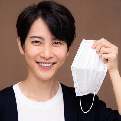 Asian woman holding white face mask