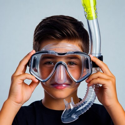 Boy holding snorkel mask and yellow snorkel