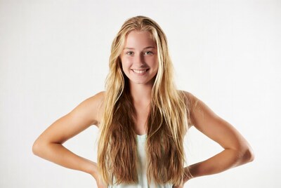 Blonde girl smiling with hands on hips
