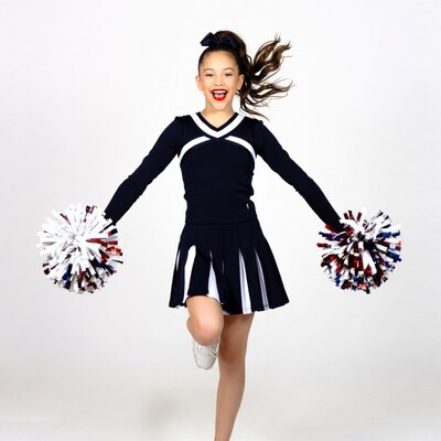 Girl cheerleader with pom poms jumping
