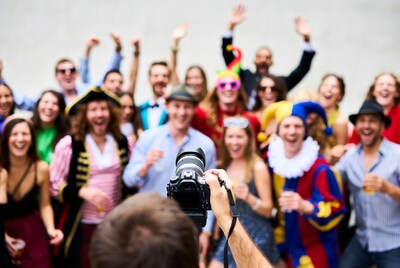 Photographer capturing costumed party crowd