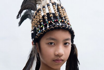 Asian girl wearing feathered headdress