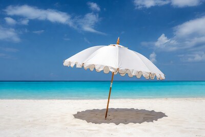 White beach umbrella on tropical sand