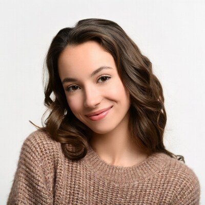 Smiling young woman in beige sweater