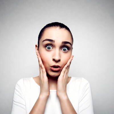 Shocked woman with hands on cheeks