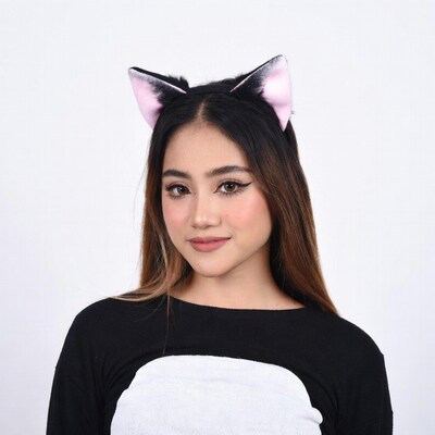 Asian woman in cat ears costume