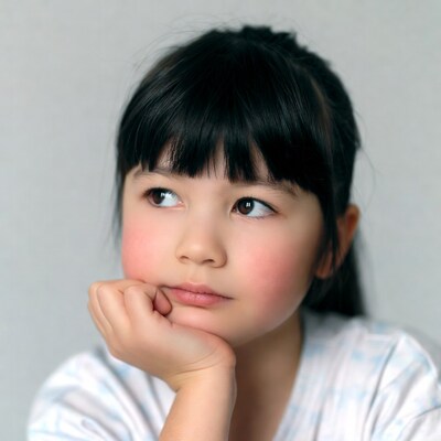 Asian girl thinking with hand on chin