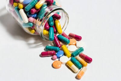 Pills spilling from glass jar