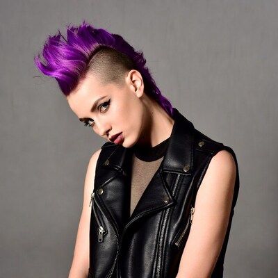 Woman with purple mohawk leather vest