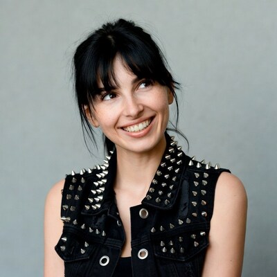 Smiling woman in studded black vest