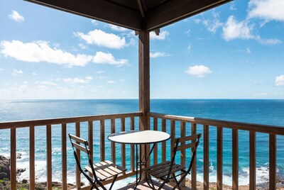 Ocean view balcony with table and chairs