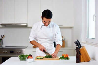 Chef chopping vegetables on cutting board