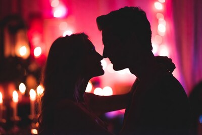 Silhouette couple nose-to-nose kissing