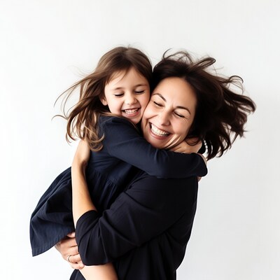 Mother hugging smiling daughter