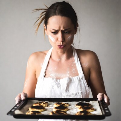 Woman holding burnt cookies apron
