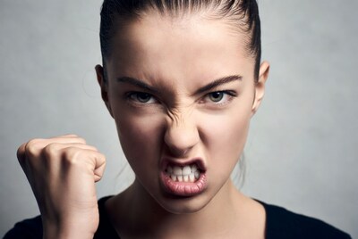 Woman making angry fist face