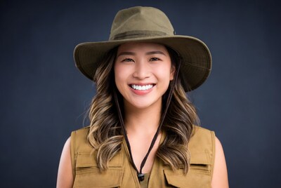 Asian woman in khaki hat and vest