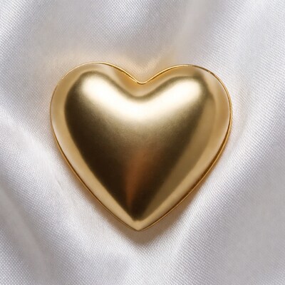 Golden heart on white satin