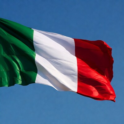 Italian flag waving against blue sky