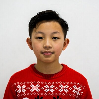 Asian boy in red Christmas sweater