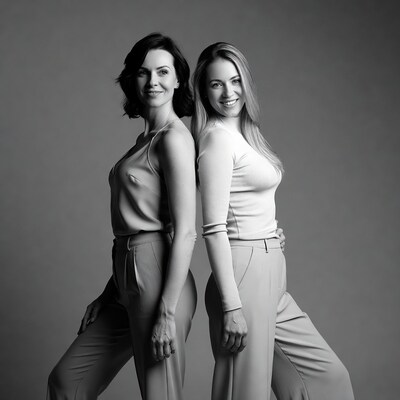 Two women posing together in studio