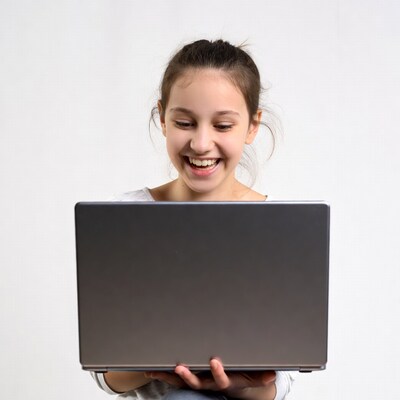 Happy girl holding laptop