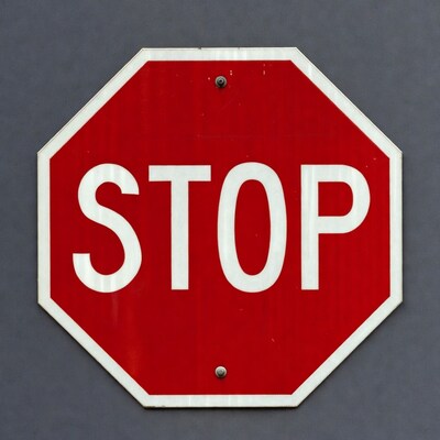 Red Stop Sign on Gray Wall