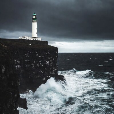 Lighthouse on cliff during stormy sea