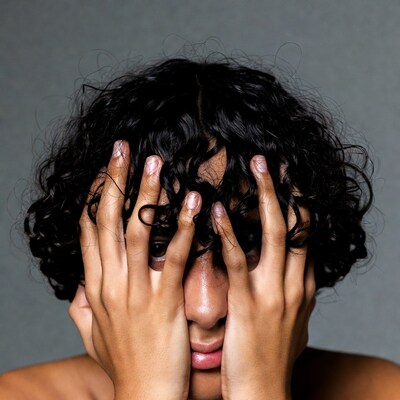 Person covering face with hands