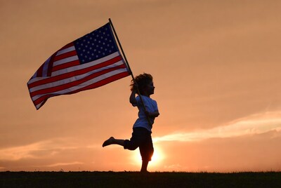 Boy running with American flag silhouette