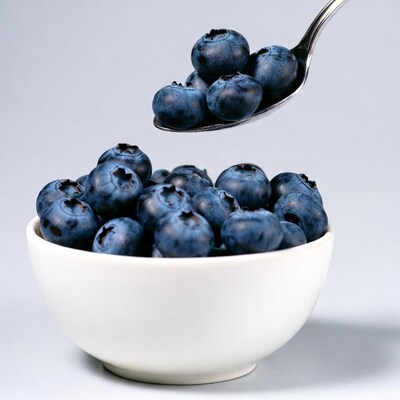 Blueberries in white bowl with spoon