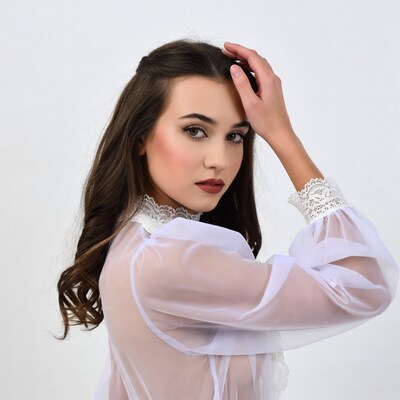 Woman in lace-trimmed sheer blouse
