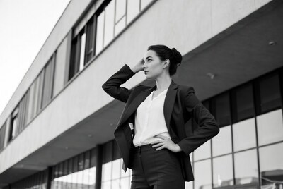 Business woman in suit against building
