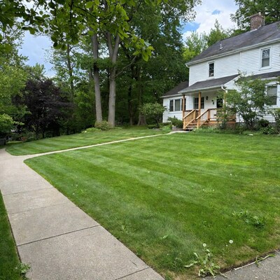 White house with green lawn and walkway