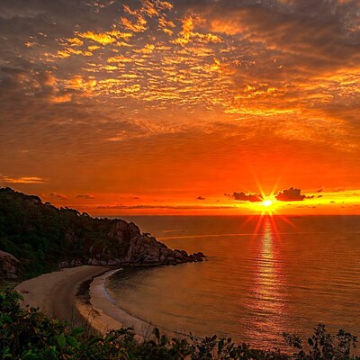Sunset over tropical beach cove
