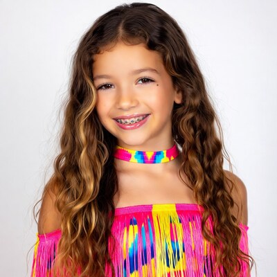 Smiling girl with braces in colorful off-shoulder top